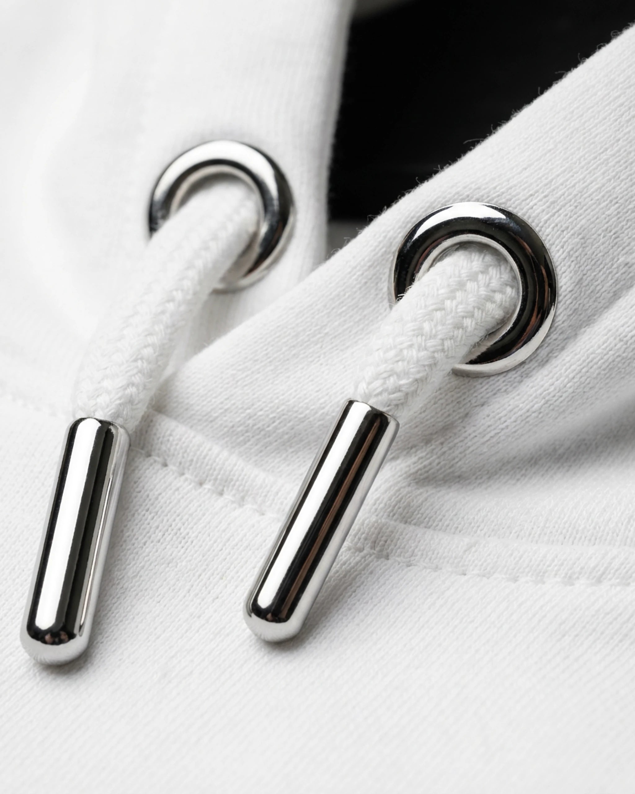 Detailaufnahme der hochwertigen Kordeln mit Metallenden am "No Problama" Hoodie in Weiss.